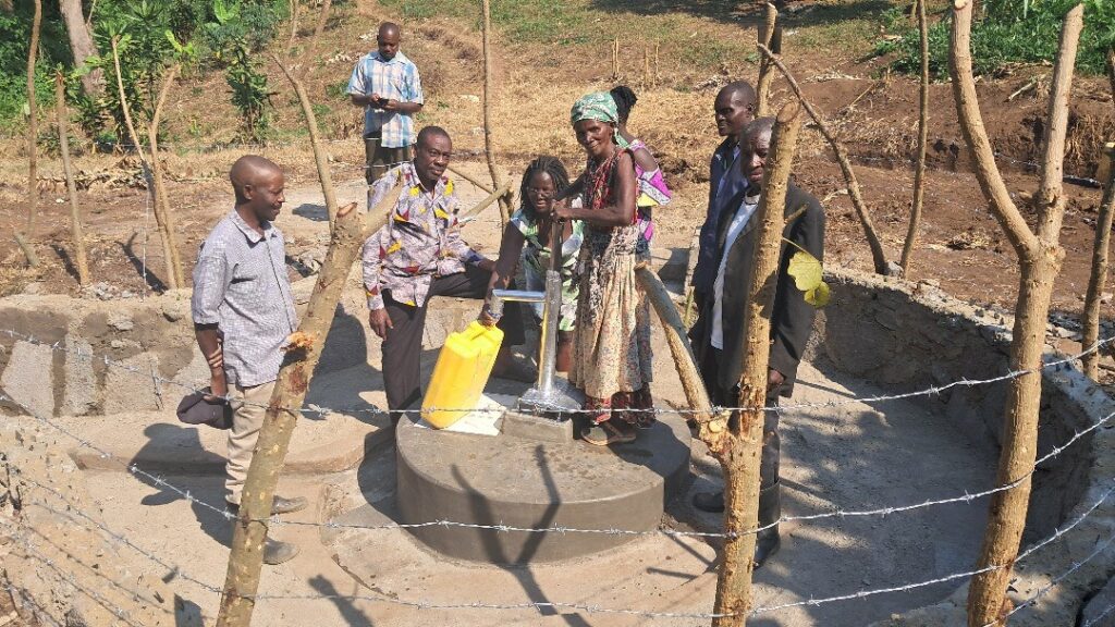 Top-down, stakeholders during the handover of the rehabilitated Buhuuna shallow well.